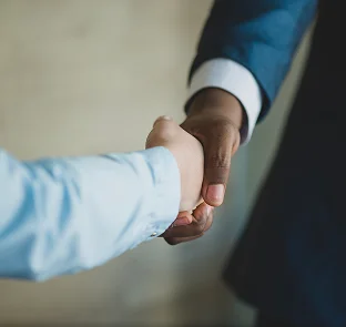 Kennedy Tax accountant and client shaking hands representing trusted professional tax and accounting services in Melbourne