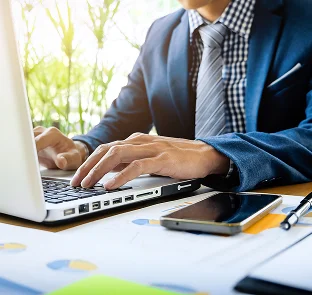 Person on laptop preparing individual and company tax returns at Kennedy Tax Melbourne